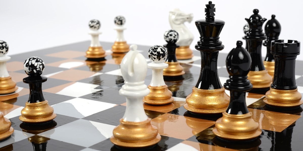 Darren-John-hand-painted-chess-set-pieces-in-play-with-Black-King