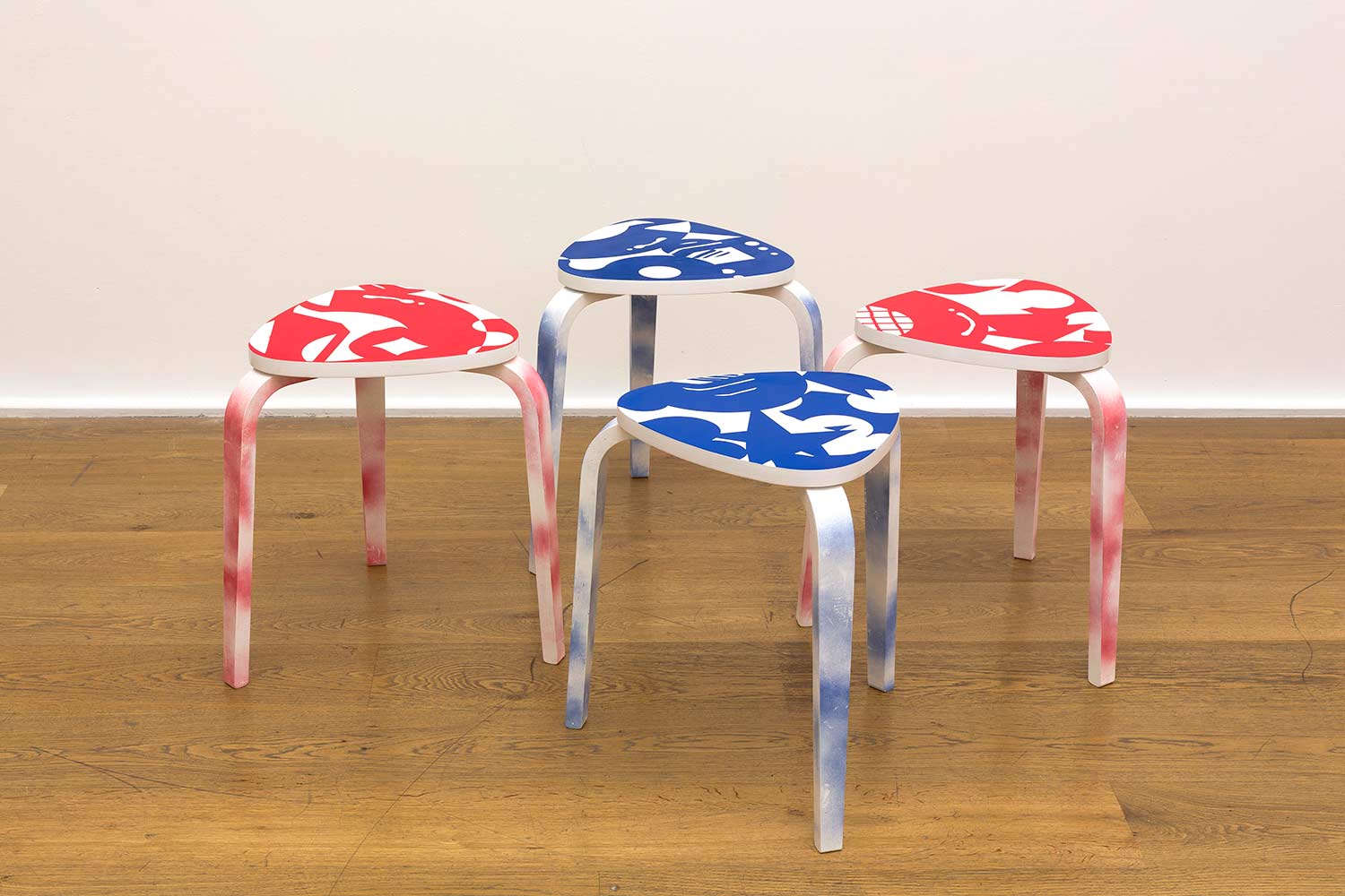 Set of stools painted by Darren John featuring abstract graphic patterns in red and blue for Hospital Rooms
